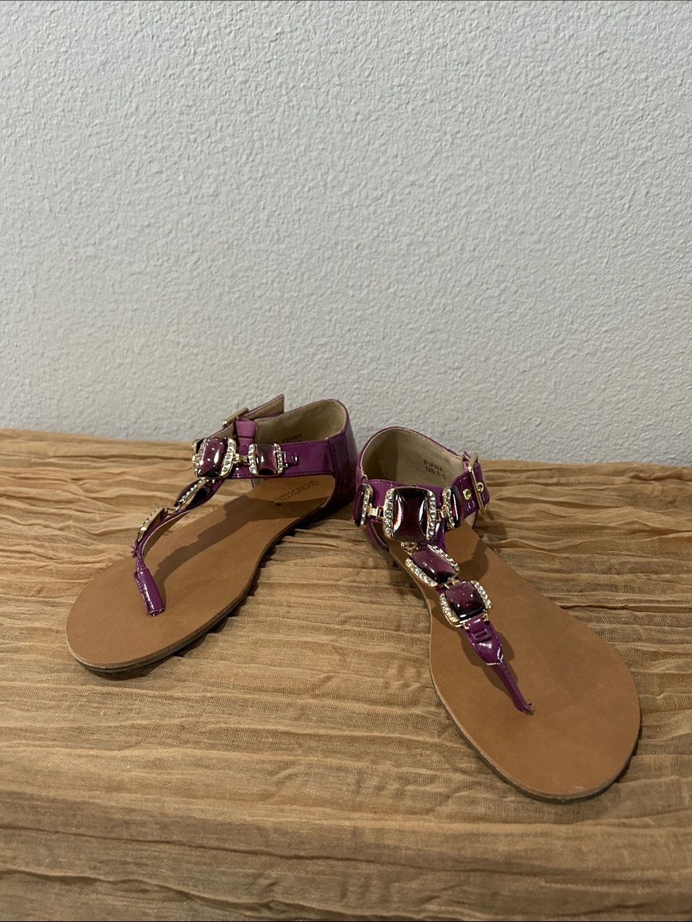 Purple sandals with metal and gemstone details